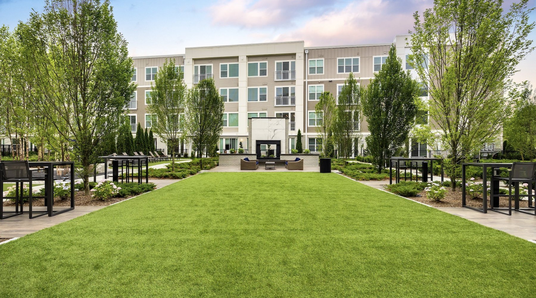 a large building with trees and grass