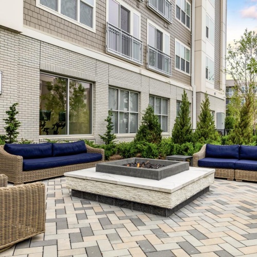 a courtyard with a fountain and chairs